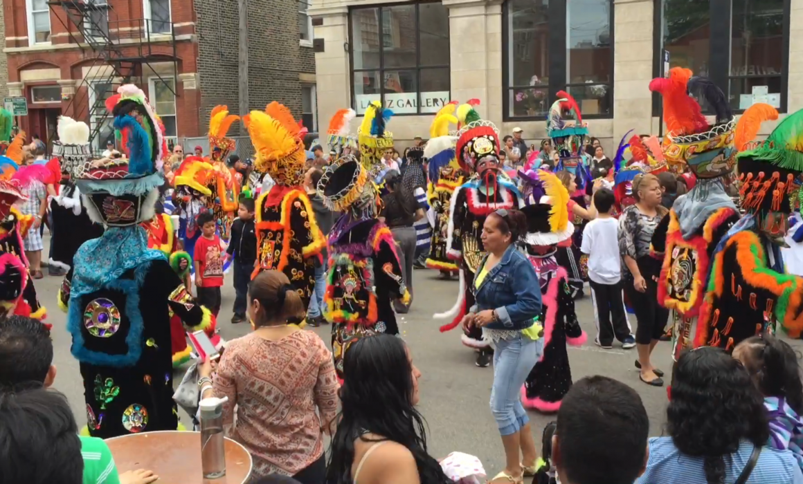 Street performers in colorful costumes at Mole de Mayo